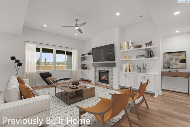 12113 Dunsmuir Dr, Pasco, WA 99301 - living room with recessed lighting, light wood-style flooring, and a stone fireplace