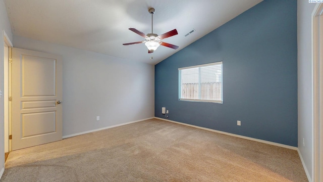 carpeted spare room featuring lofted ceiling and ceiling fan