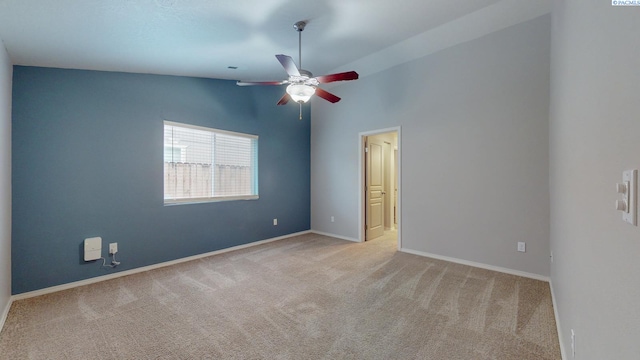 unfurnished room with vaulted ceiling, ceiling fan, and light colored carpet