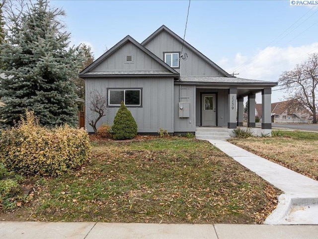 view of front of property with a porch and a front lawn