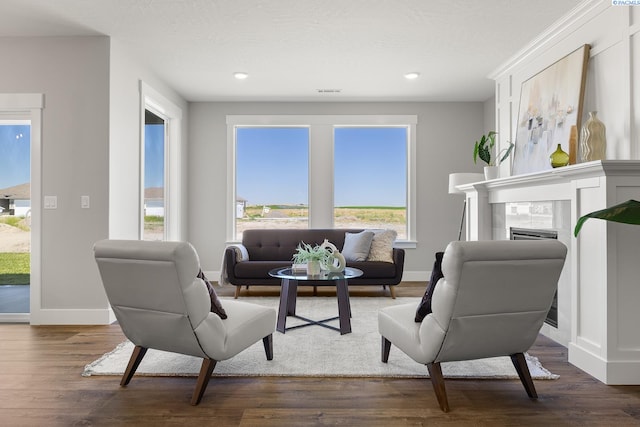 8717 Ashen Dr, Pasco, WA 99301 - living area featuring a tile fireplace, baseboards, healthy amount of natural light, dark wood-style flooring, and recessed lighting