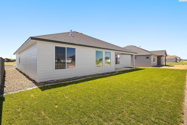 8717 Ashen Dr, Pasco, WA 99301 - rear view of property with a lawn and a shingled roof