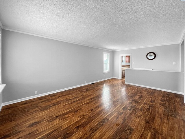 spare room featuring crown molding, dark hardwood / wood-style floors, and a textured ceiling