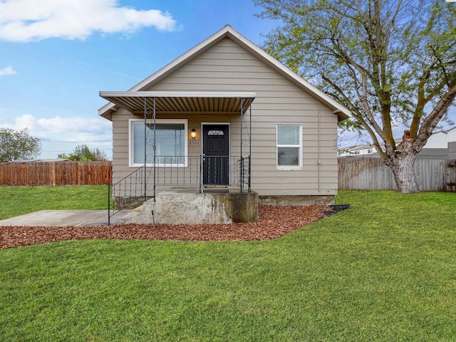 bungalow-style house with a front yard