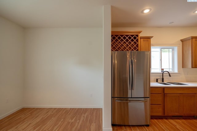 1205 SW Hannah St, Pullman, WA 99163 - kitchen with a sink, a kitchen breakfast bar, stainless steel appliances, and light wood finished floors