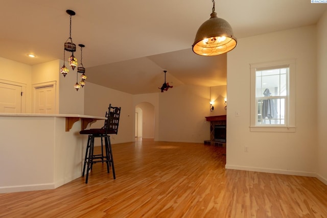 1205 SW Hannah St, Pullman, WA 99163 - unfurnished living room featuring light wood-style flooring, a fireplace with raised hearth, and arched walkways