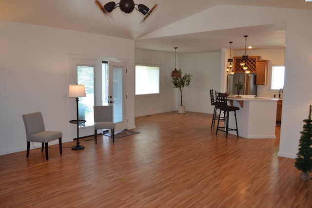 1205 SW Hannah St, Pullman, WA 99163 - living room with light wood-type flooring, vaulted ceiling, and a chandelier