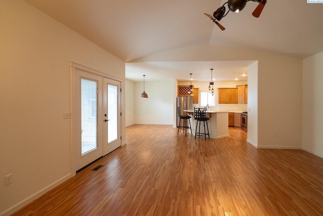1205 SW Hannah St, Pullman, WA 99163 - living room with ceiling fan, light wood finished floors, baseboards, vaulted ceiling, and visible vents