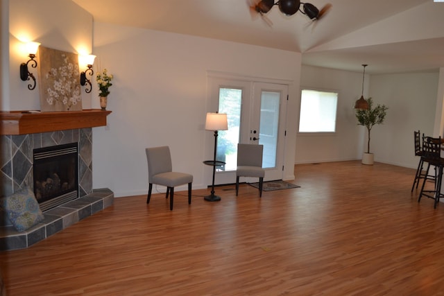 1205 SW Hannah St, Pullman, WA 99163 - sitting room featuring wood finished floors, vaulted ceiling, a tiled fireplace, and ceiling fan