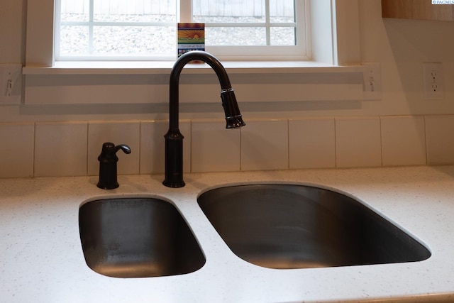 1205 SW Hannah St, Pullman, WA 99163 - details featuring a sink, decorative backsplash, and light stone countertops
