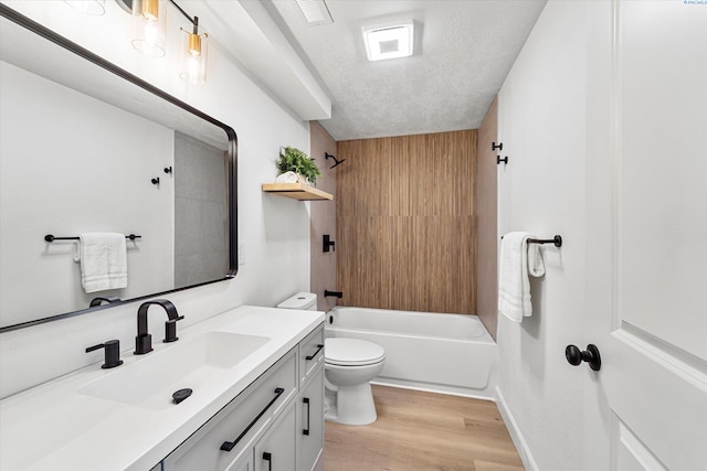 2008 Tinkle St, Richland, WA 99352 - full bath featuring toilet, wood finished floors, shower / bathtub combination, vanity, and a textured ceiling