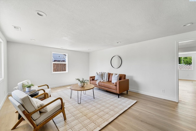 2008 Tinkle St, Richland, WA 99352 - living room with a textured ceiling, light wood finished floors, baseboards, and recessed lighting