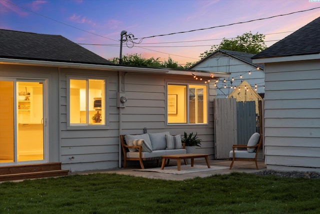 2008 Tinkle St, Richland, WA 99352 - back of house at dusk featuring entry steps, an outdoor living space, a shingled roof, and a patio area