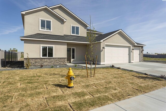 traditional-style home with an attached garage, stone siding, fence, stucco siding, and driveway