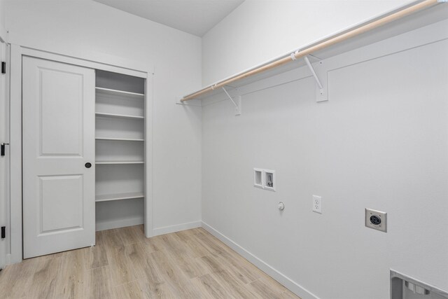laundry room with electric dryer hookup, baseboards, washer hookup, laundry area, and light wood finished floors