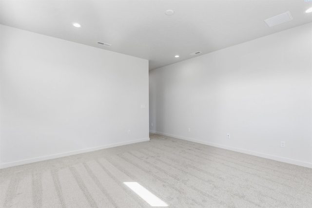 unfurnished room featuring light carpet, baseboards, and recessed lighting