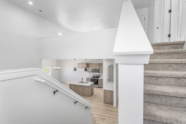 stairs featuring recessed lighting, a high ceiling, and wood finished floors