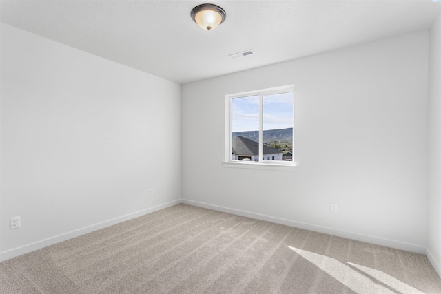 unfurnished room featuring visible vents, baseboards, and carpet flooring
