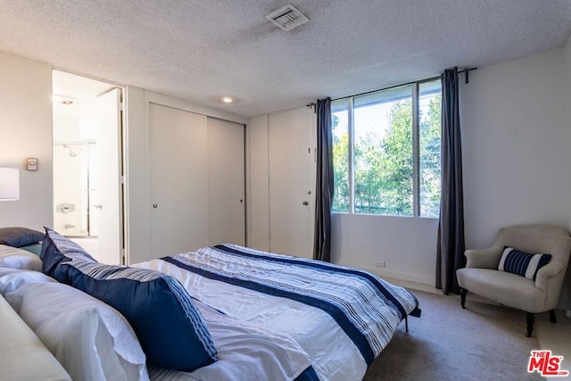 carpeted bedroom featuring a textured ceiling