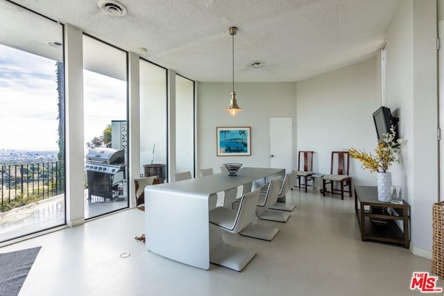 dining room with floor to ceiling windows and a textured ceiling