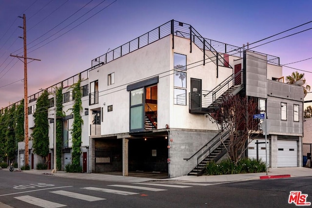 outdoor building at dusk with a garage