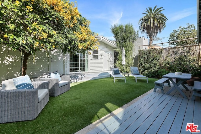 view of yard featuring a wooden deck and an outdoor hangout area