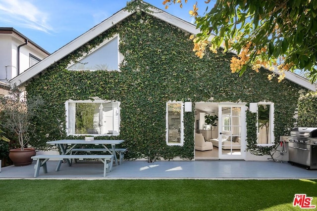 rear view of house featuring a yard