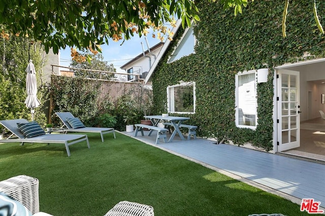 view of yard with a wooden deck and a patio area