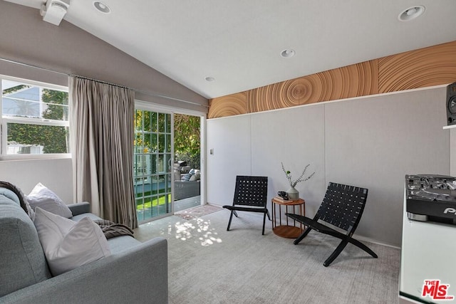 sitting room with lofted ceiling and light colored carpet