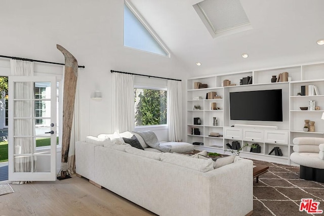 living room with high vaulted ceiling and dark wood-type flooring