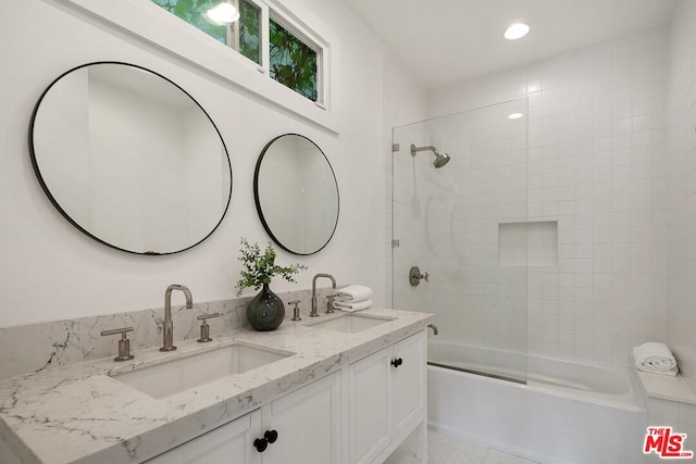 bathroom with tiled shower / bath combo, tile floors, and dual vanity