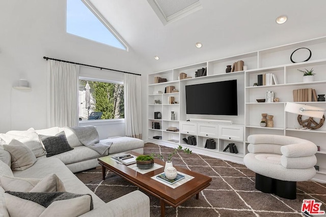 living room with high vaulted ceiling