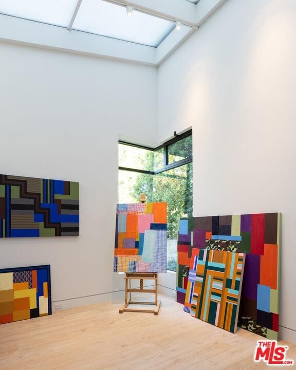 playroom featuring a towering ceiling and rail lighting