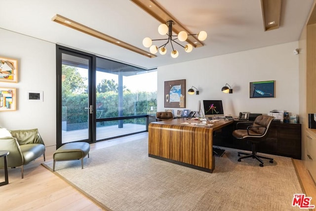 home office featuring a wall of windows, a notable chandelier, and light wood-type flooring