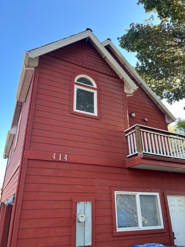 view of side of home with a balcony