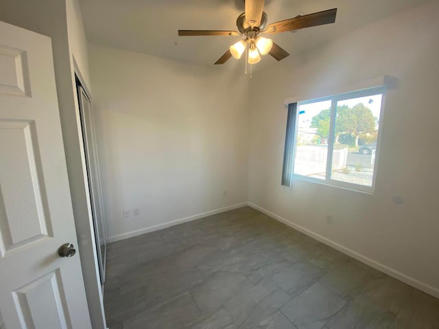 tiled empty room with ceiling fan