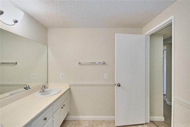 bathroom featuring a textured ceiling and vanity with extensive cabinet space