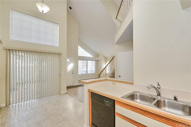 kitchen with light tile flooring, high vaulted ceiling, white cabinets, dishwasher, and pendant lighting