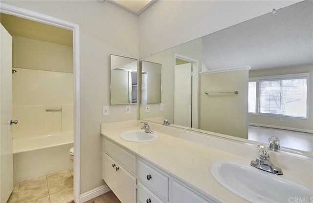 full bathroom with  shower combination, toilet, dual bowl vanity, and tile flooring