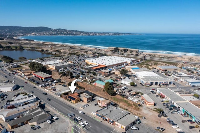 drone / aerial view featuring a beach view and a water view