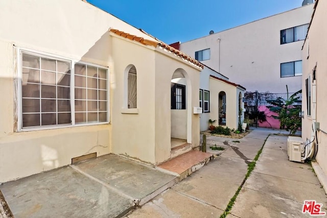 view of side of home featuring a patio area