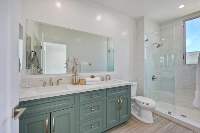 bathroom featuring double sink, toilet, large vanity, and walk in shower