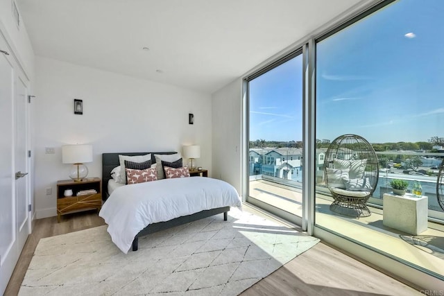 bedroom featuring light hardwood / wood-style floors and access to exterior