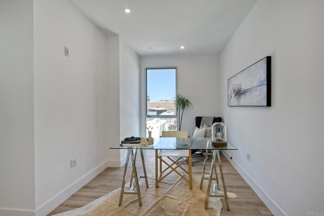 home office with light hardwood / wood-style flooring