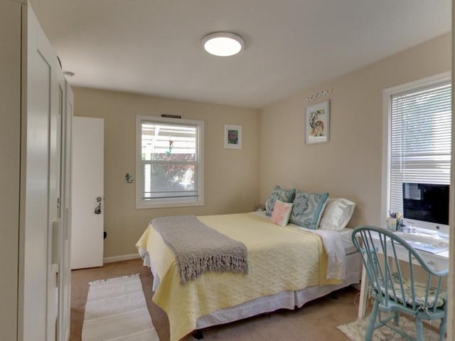 bedroom featuring light carpet