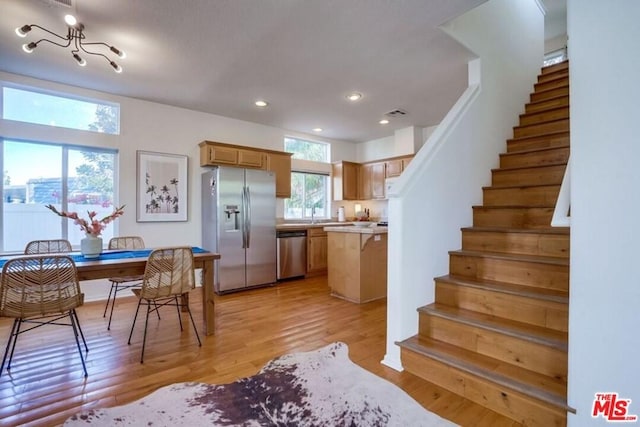 interior space featuring light hardwood / wood-style floors and a notable chandelier