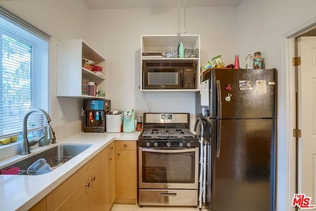 kitchen featuring hanging light fixtures, black appliances, and sink