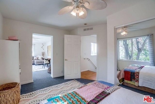 bedroom with ceiling fan and dark carpet