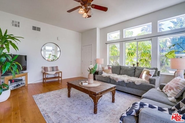 living room featuring light hardwood / wood-style flooring and ceiling fan