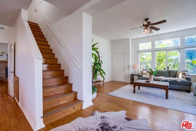 living room featuring ceiling fan and light wood-type flooring